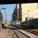 Ci muoviamo verso la periferia e dopo qualche decina di metri il caseggiato lascia a spazio a un largo marciapiede: lo percorriamo fin quasi al ponte Garibaldi, trovando alla nostra destra l'ingresso della piccola stazione Marconi